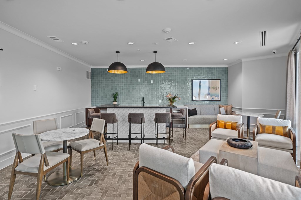 A modern living room with a glass backsplash and a variety of seating options.