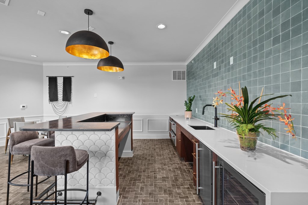 A kitchen with a white counter top and a tile backsplash.