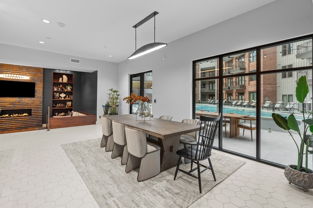 A modern dining room with a long table and chairs.