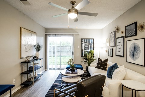 our apartments offer a living room with a ceiling fan and a balcony