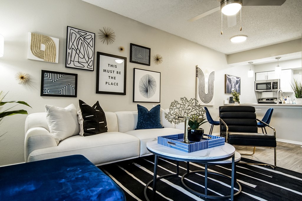 an open living room with a white couch and a coffee table