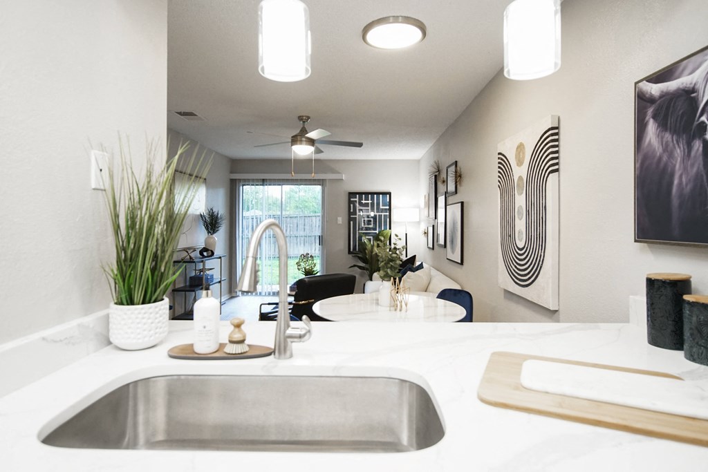 the view of the kitchen and living room from the counter top in a modern home