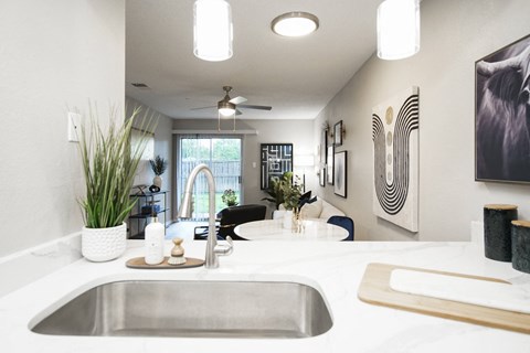 the view of the kitchen and living room from the counter top in a modern home