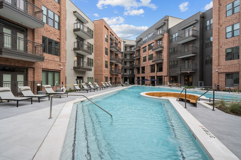 A swimming pool in front of apartment buildings.
