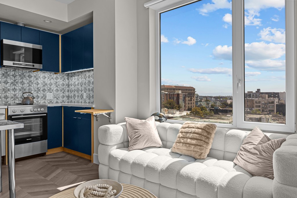 A modern kitchen with a view of the cityscape outside the window.