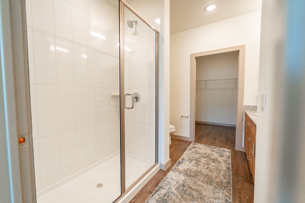 A bathroom with a walk-in shower and a towel bar.