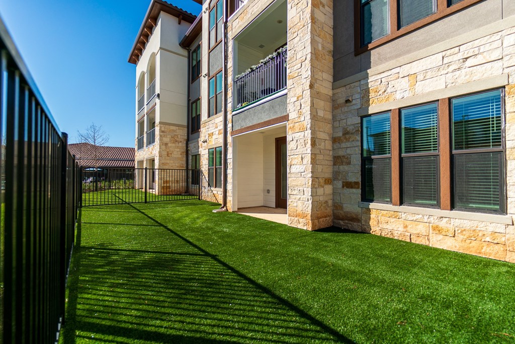A sunny day at a residential building with a green lawn.