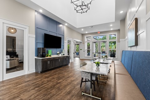 A modern living room with a dining table and a television.