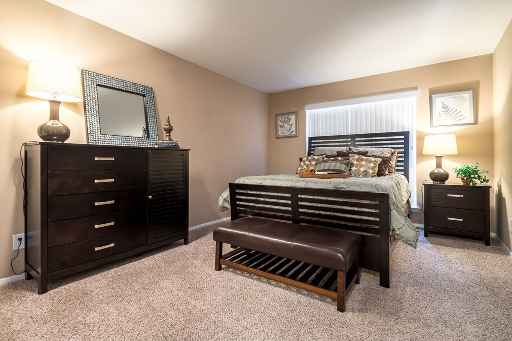 a bedroom with a bed and a dresser