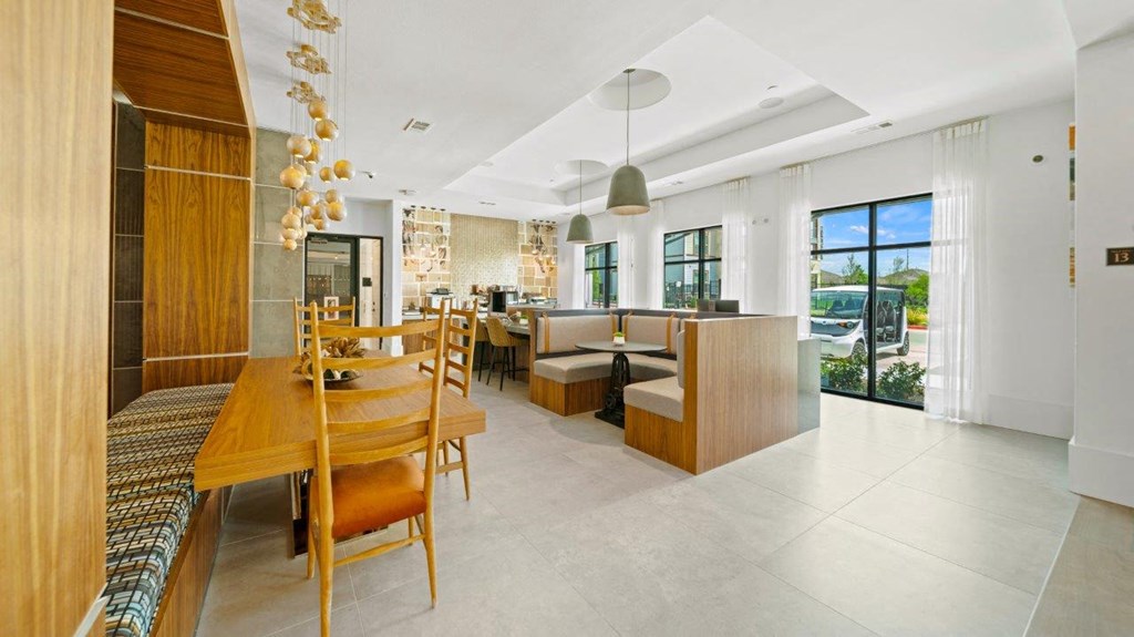 a dining room and living room with a wooden table and chairs