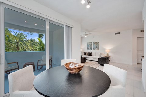 A modern dining room with a table and chairs.