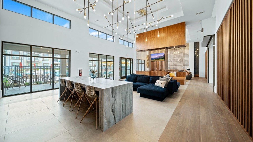 a large living room with a kitchen and a long table