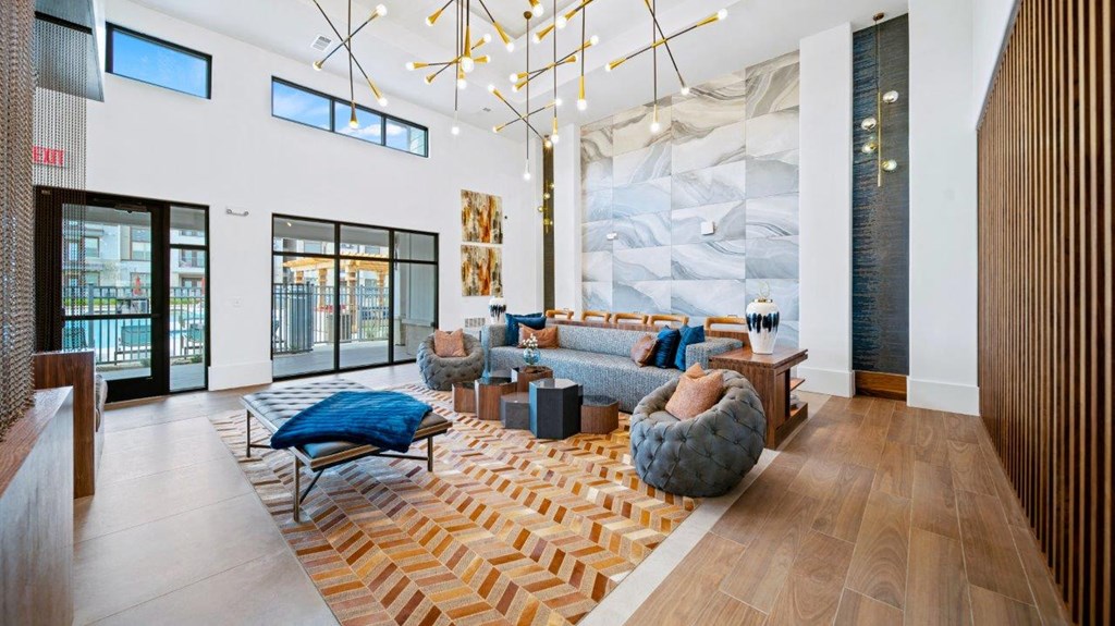 a living room with furniture and a large wall of windows