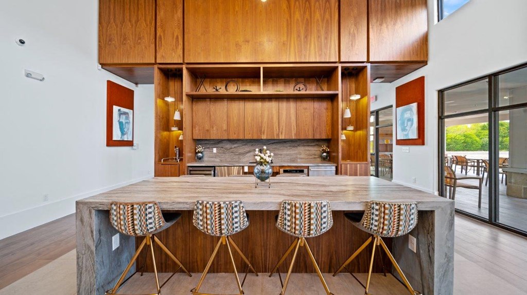 the kitchen has a large island with bar stools