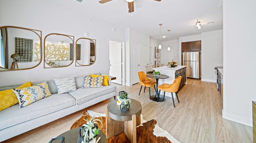 a living room with a couch and a dining room table