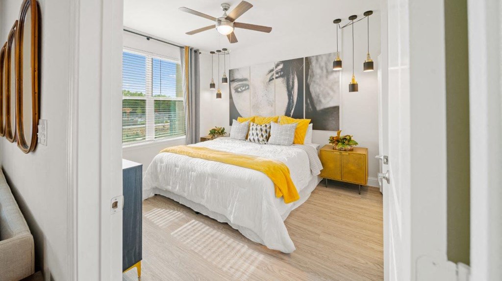 a bedroom with a bed and a ceiling fan