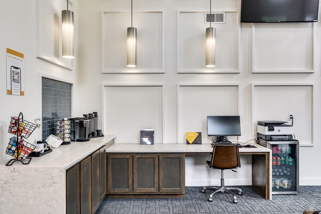 A modern office with a white wall and a wooden desk.