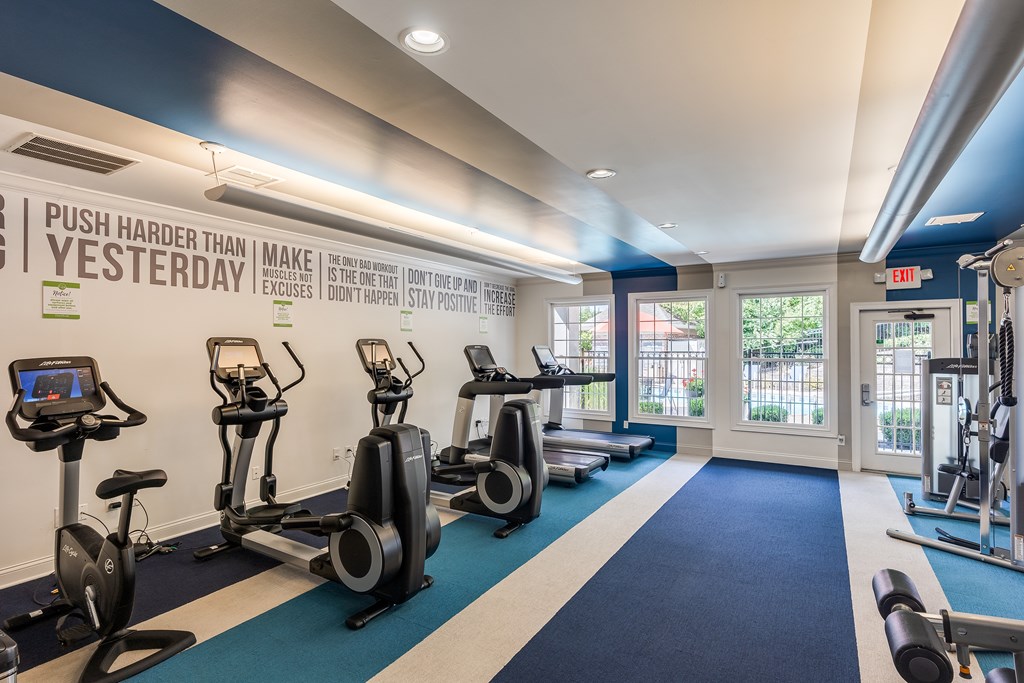 A gym with a row of stationary bikes and a sign that says
