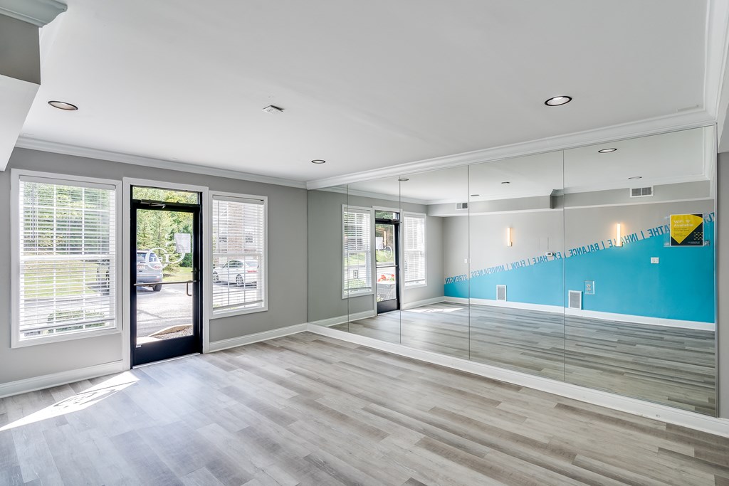 A room with a blue wall and wooden flooring.