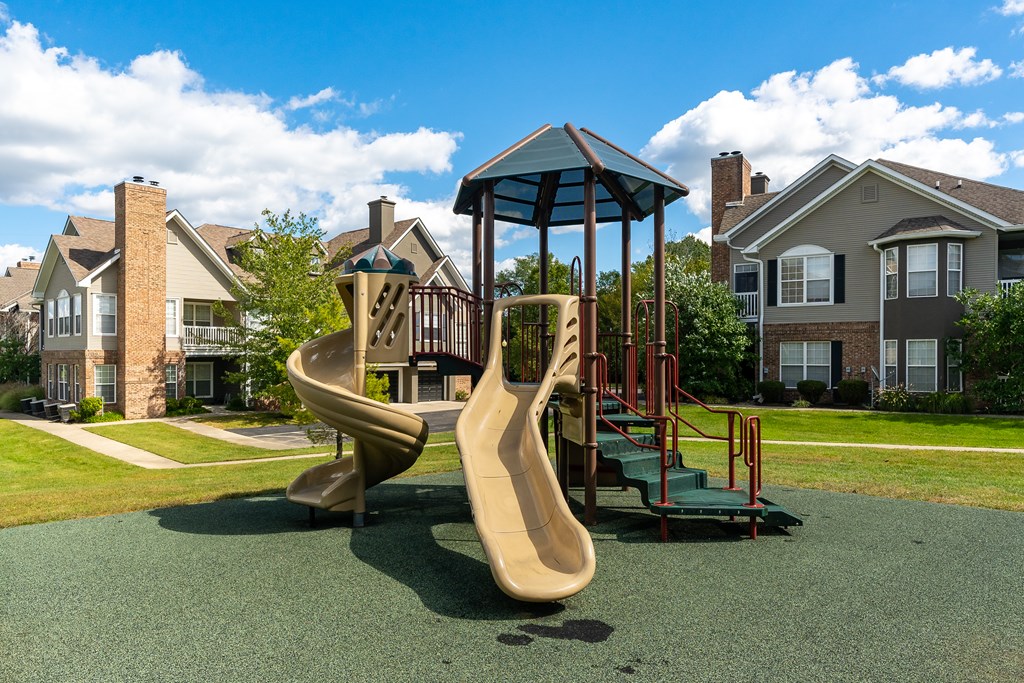 A playground with a slide and a swing set.