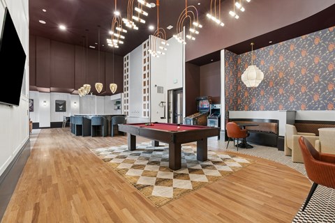 A room with a pool table and a checkered floor.