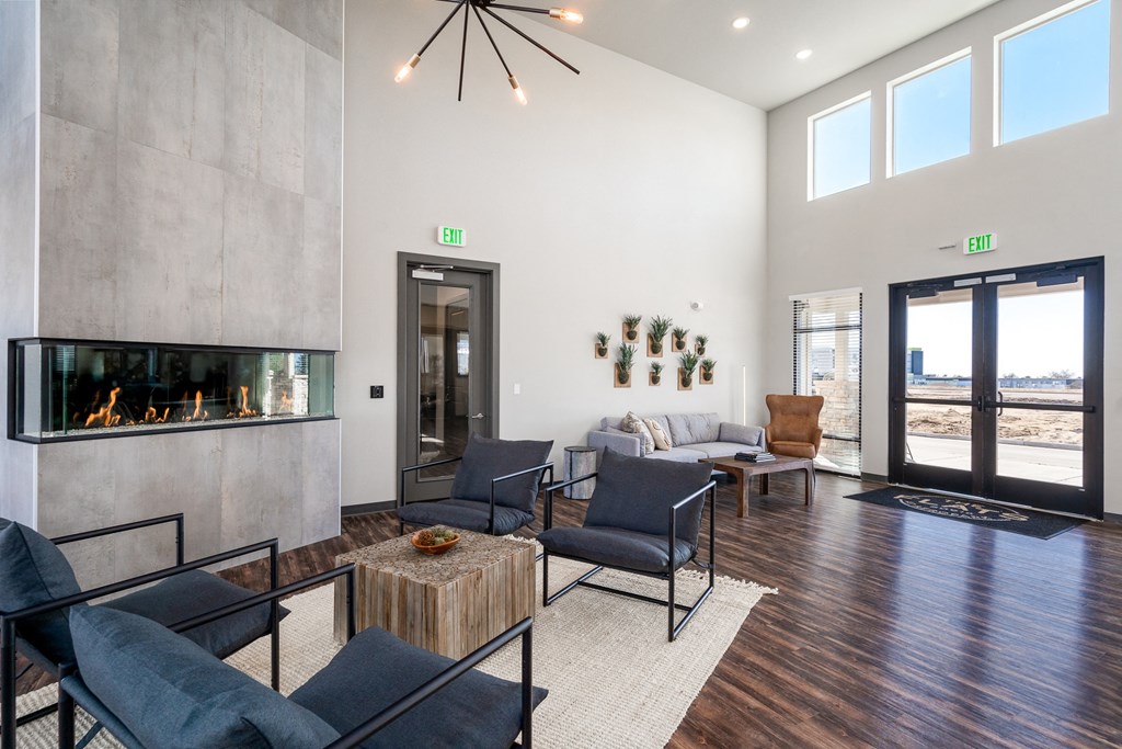a living room with couches and chairs and a fireplace