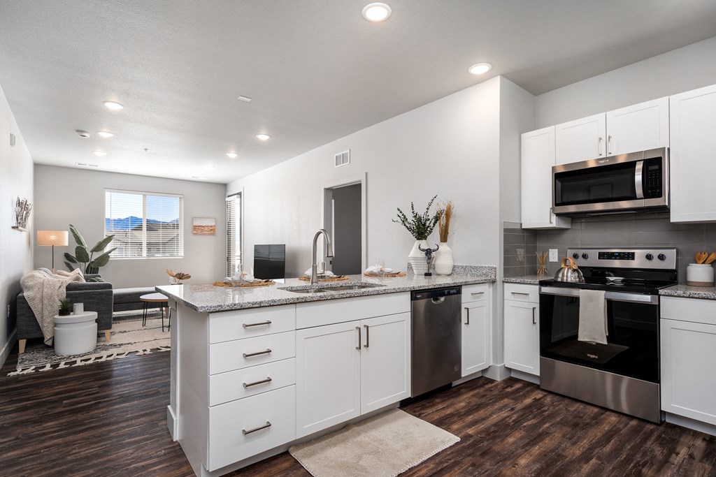 a kitchen with white cabinets and stainless steel appliances