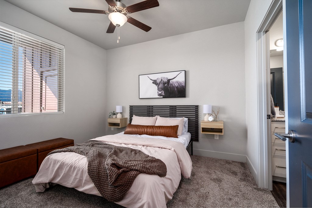 a bedroom with a bed and a ceiling fan