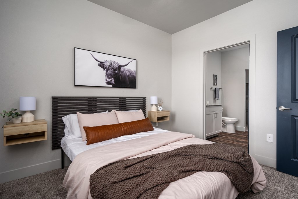 a bedroom with a bed and a picture of a bull