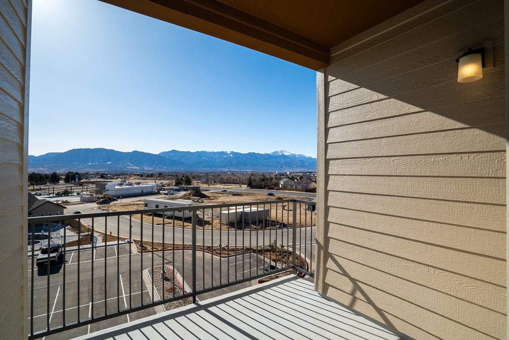 the view of the city from the balcony of a home with a railing