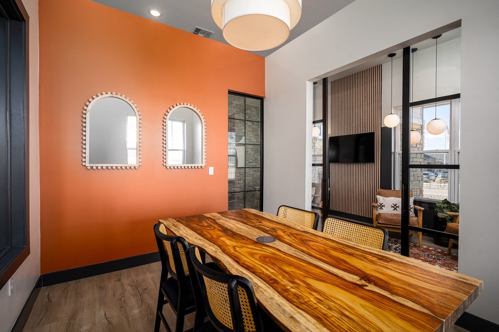 a dining room with a wooden table and chairs
