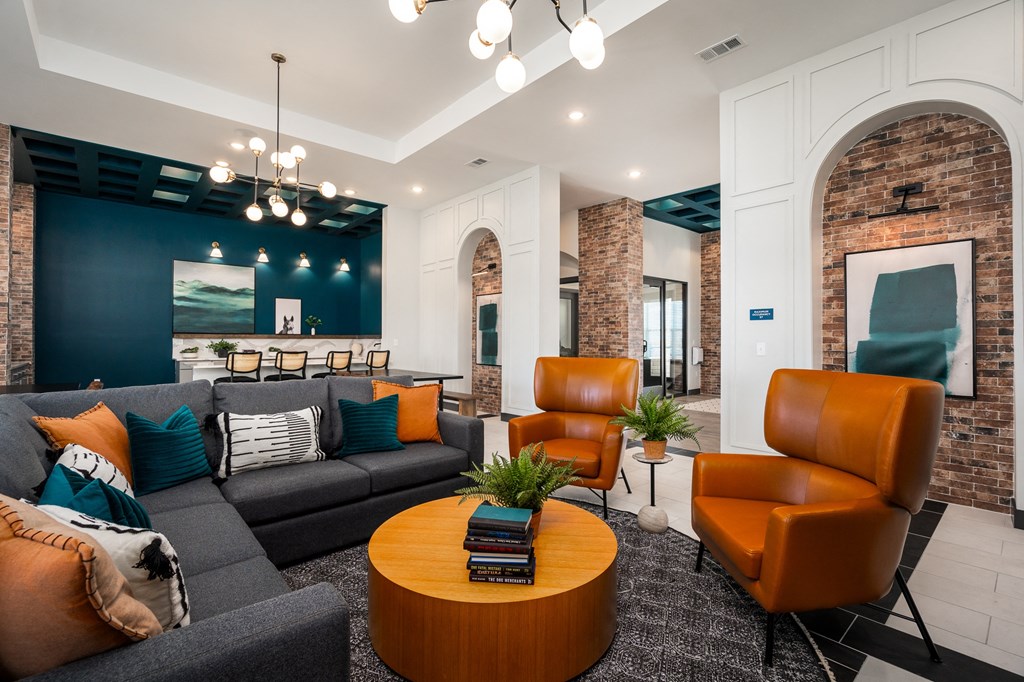 a living room with couches and chairs and a table