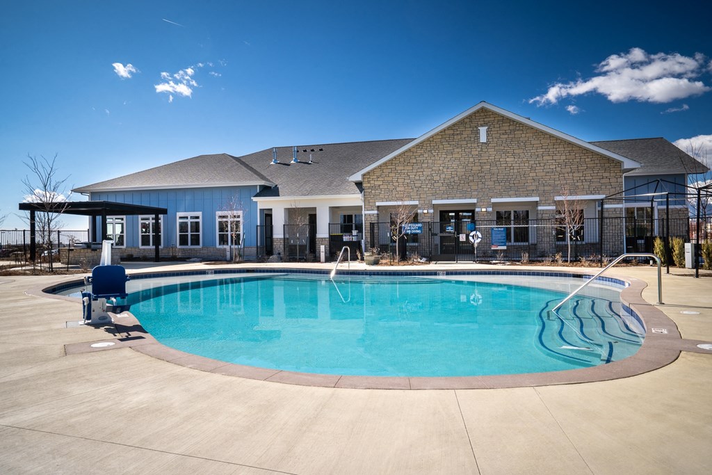 a swimming pool with a house in the background