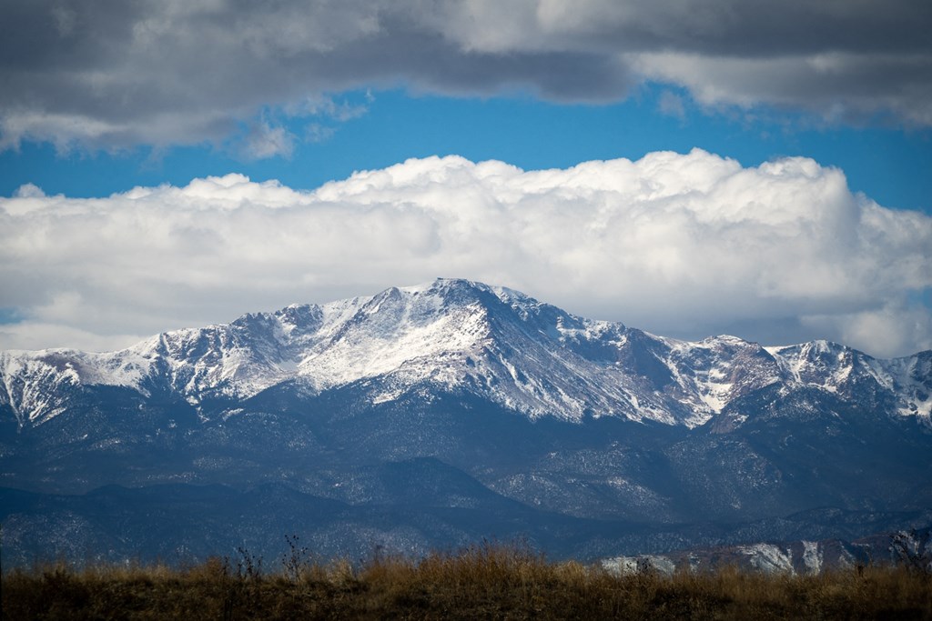a view of the mountains with clouds in the sky