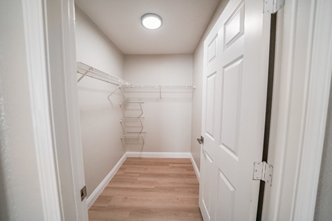 A white door is on the right side of a hallway.