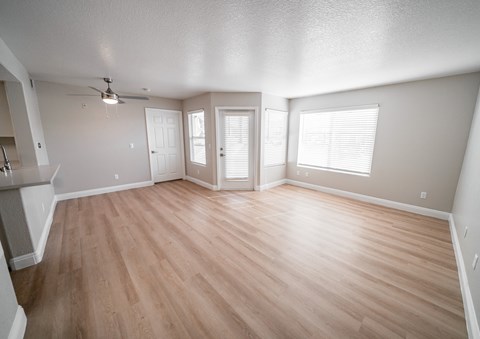 A room with wooden floors and a ceiling fan.