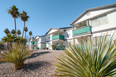 a row of houses with palm trees in front of them