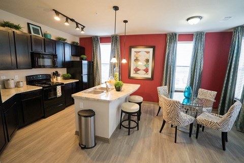 a kitchen and dining room with a table and chairs