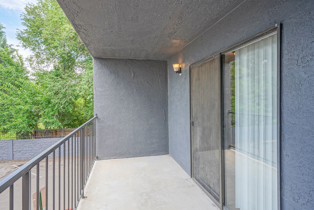a balcony with a glass door and a glass sliding glass door to a patio