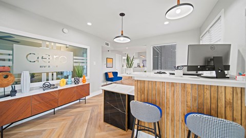 a kitchen with a counter top and a desk with chairs