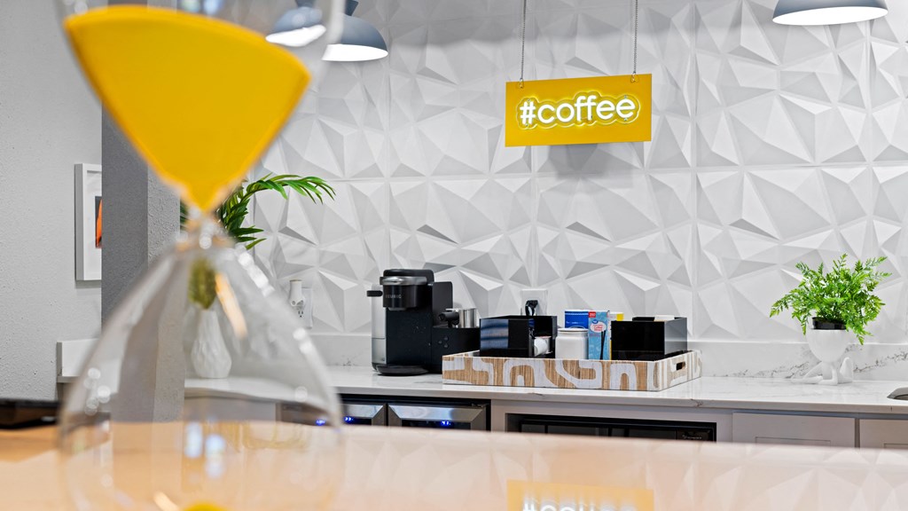 a table with a martini glass and a sign that says coffee