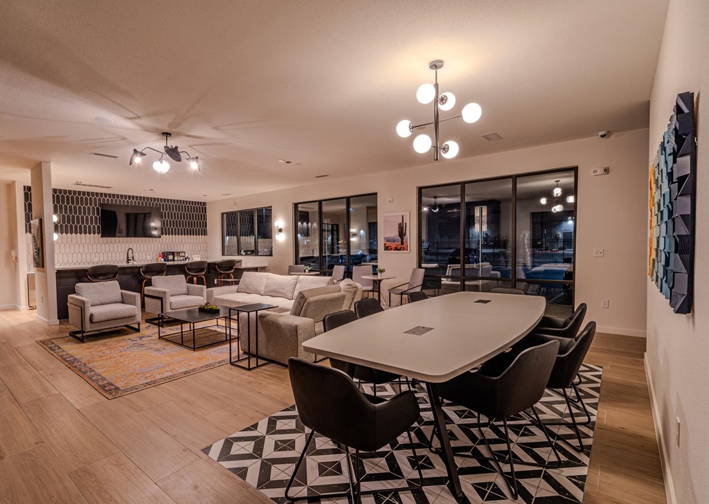 a living room and dining room with a table and chairs
