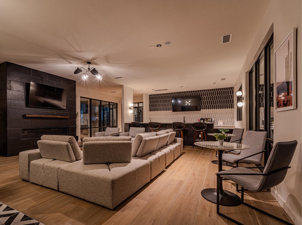 a living room with couches and chairs and a television