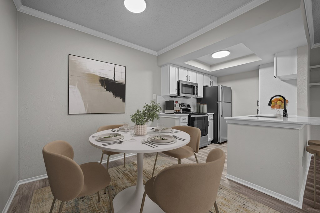 A modern kitchen with a dining table set for four.