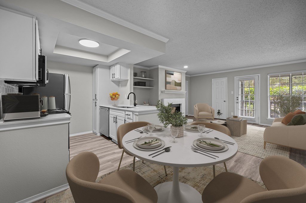 A modern kitchen with a dining table set for two.