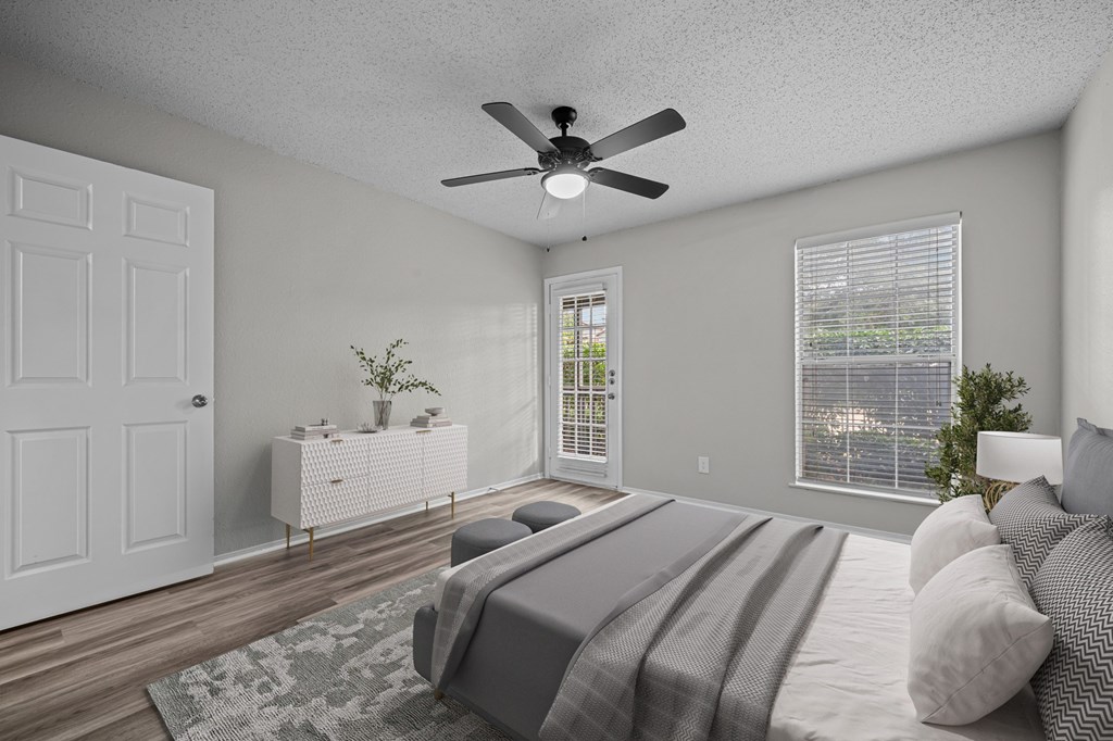 A bedroom with a bed, dresser, and window.
