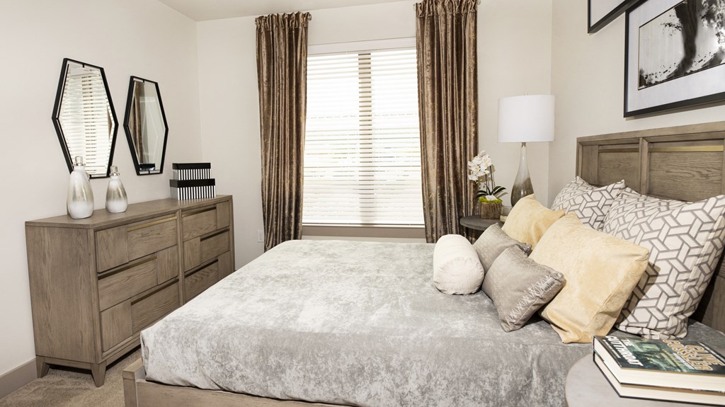 a bedroom with a large bed and a window