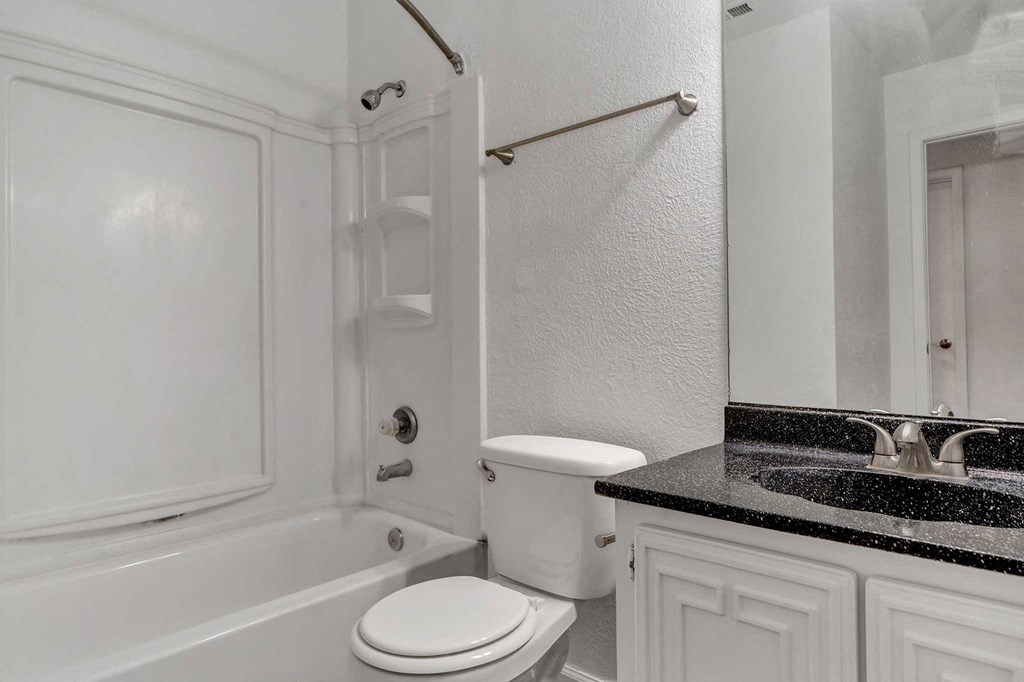 a bathroom with a sink toilet and bathtub