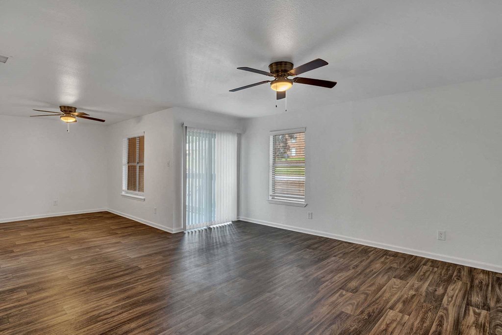 a bedroom with hardwood floors and a ceiling fan