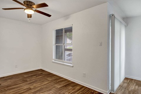 a living room with a ceiling fan and a window